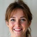 Portrait of Emily Carter, a smiling and confident woman who owns an online boutique.